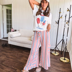 Thin, lightweight textured wide leg pant with red, blue and cream stripes with elastic drawstring waist and side pockets.