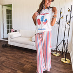Thin, lightweight textured wide leg pant with red, blue and cream stripes with elastic drawstring waist and side pockets.