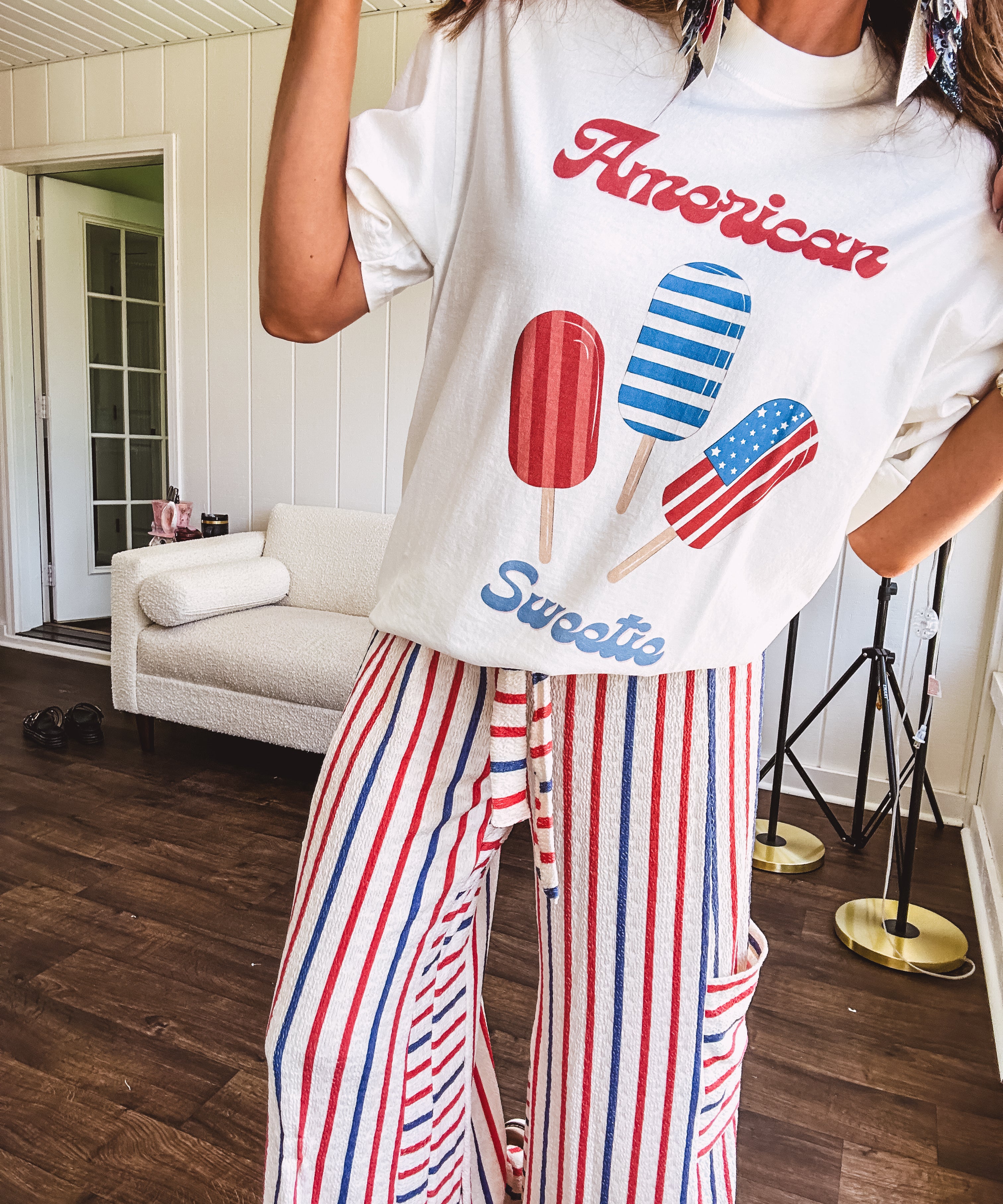 White cotton tee with blue and red "American Sweet" and popsicle graphics on front.