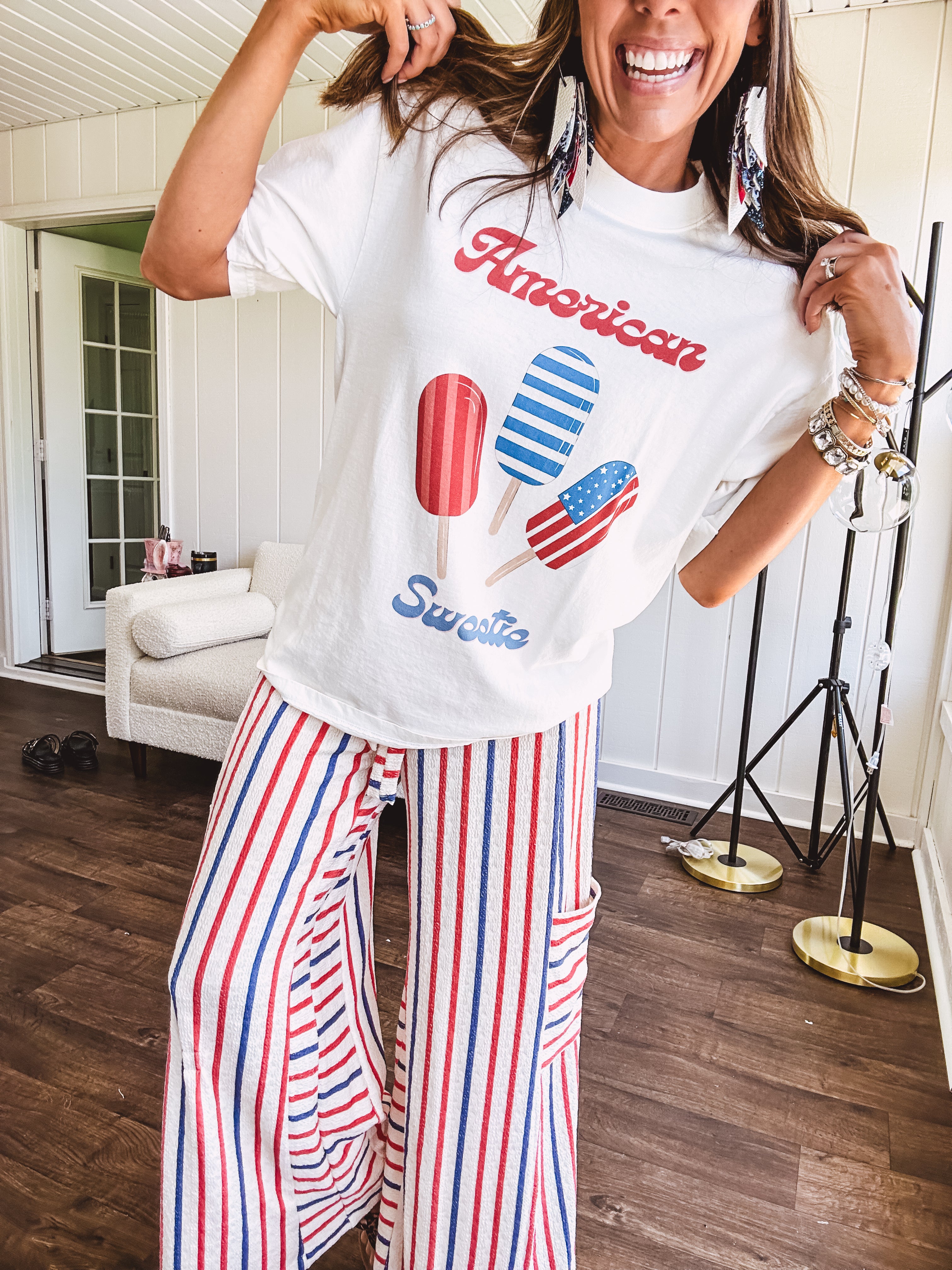 White cotton tee with blue and red "American Sweet" and popsicle graphics on front.