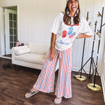 Thin, lightweight textured wide leg pant with red, blue and cream stripes with elastic drawstring waist and side pockets.