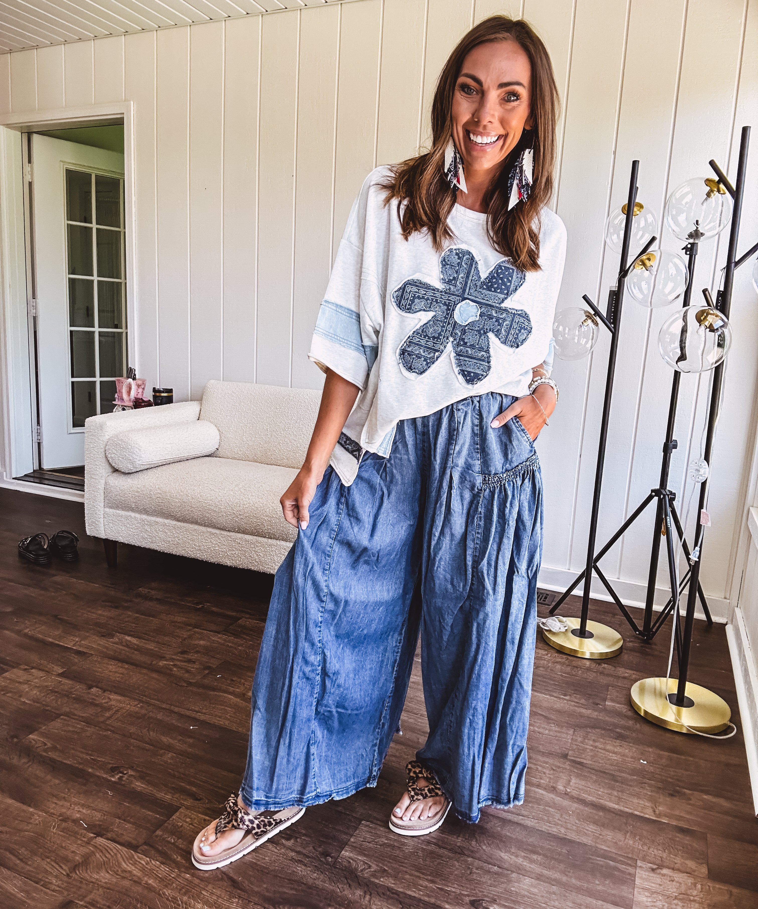 Soft, thin, lightweight 3/4 sleeve heather grey top with denim blue floral patchwork on the front and light blue patchwork on the sleeves and trim.