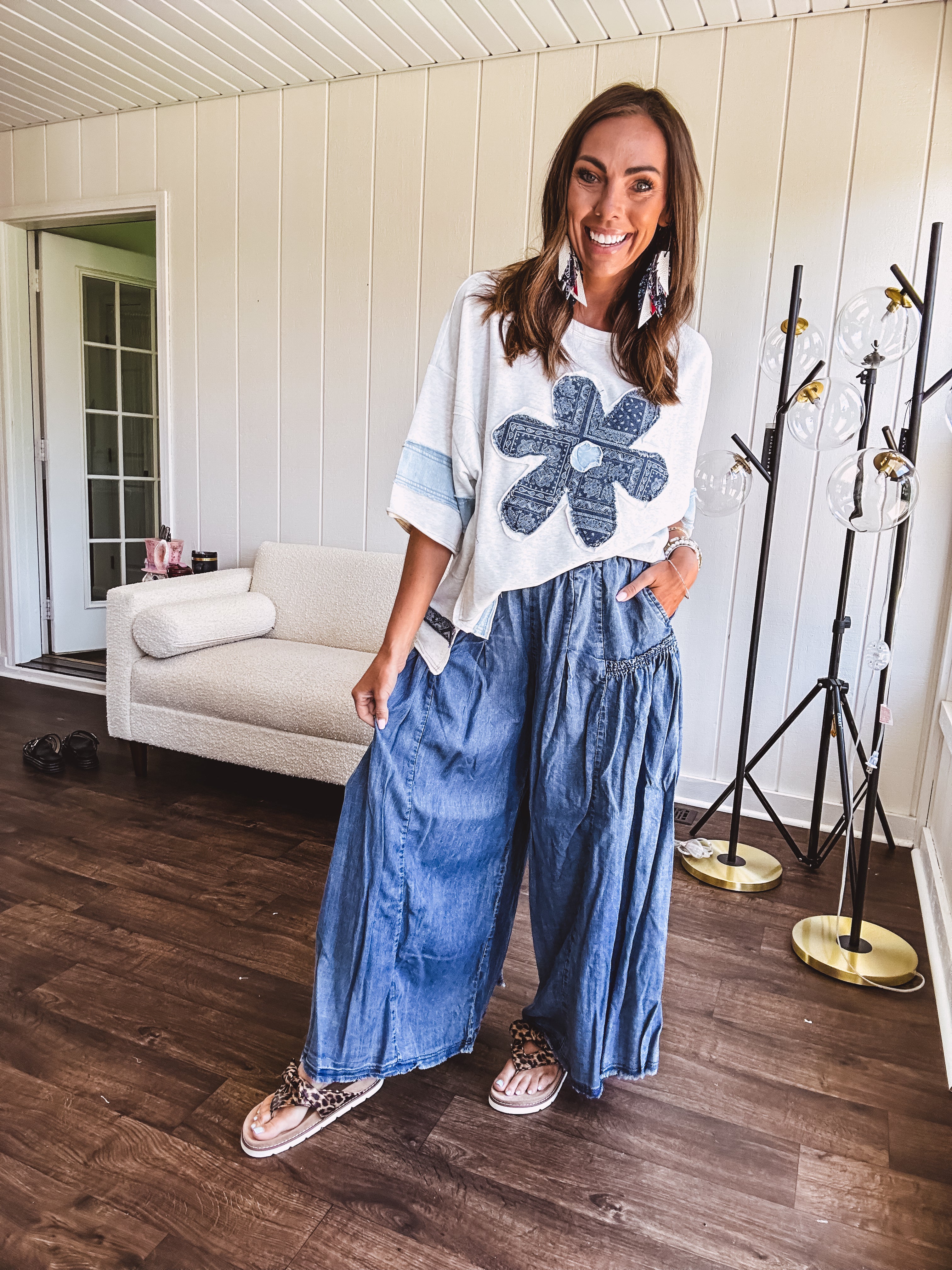 Soft, thin, lightweight 3/4 sleeve heather grey top with denim blue floral patchwork on the front and light blue patchwork on the sleeves and trim.