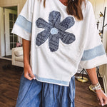 Soft, thin, lightweight 3/4 sleeve heather grey top with denim blue floral patchwork on the front and light blue patchwork on the sleeves and trim.