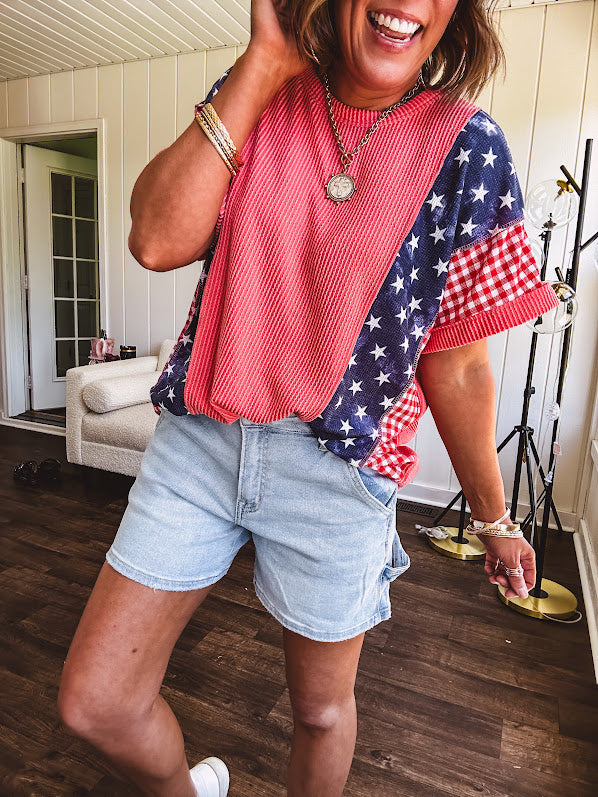 Washed red urban ribbed tee with red and white gingham and navy stars and stripes patchwork down the sides and shoulders.