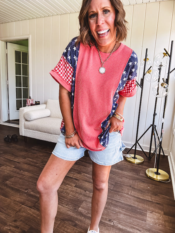 Washed red urban ribbed tee with red and white gingham and navy stars and stripes patchwork down the sides and shoulders.