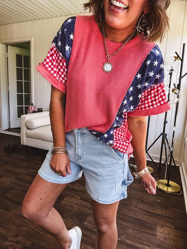 Washed red urban ribbed tee with red and white gingham and navy stars and stripes patchwork down the sides and shoulders.