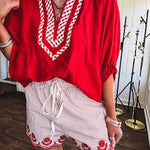 Cotton blend red and white striped shorts with elastic drawstring waist and embroidered red scalloped hem and pockets.