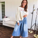 Light wash wide leg denim culottes with pleating at the top, button fly and pockets.