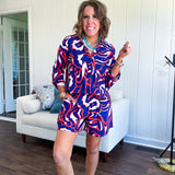 Soft, lightweight set featuring a 3/4 tab sleeve top with button down front and collar with matching elastic waist shorts with front pleats and pockets as well as lining in a bold navy, orange and white modern print.