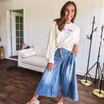 Light wash wide leg denim culottes with pleating at the top, button fly and pockets.