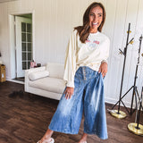 Light wash wide leg denim culottes with pleating at the top, button fly and pockets.