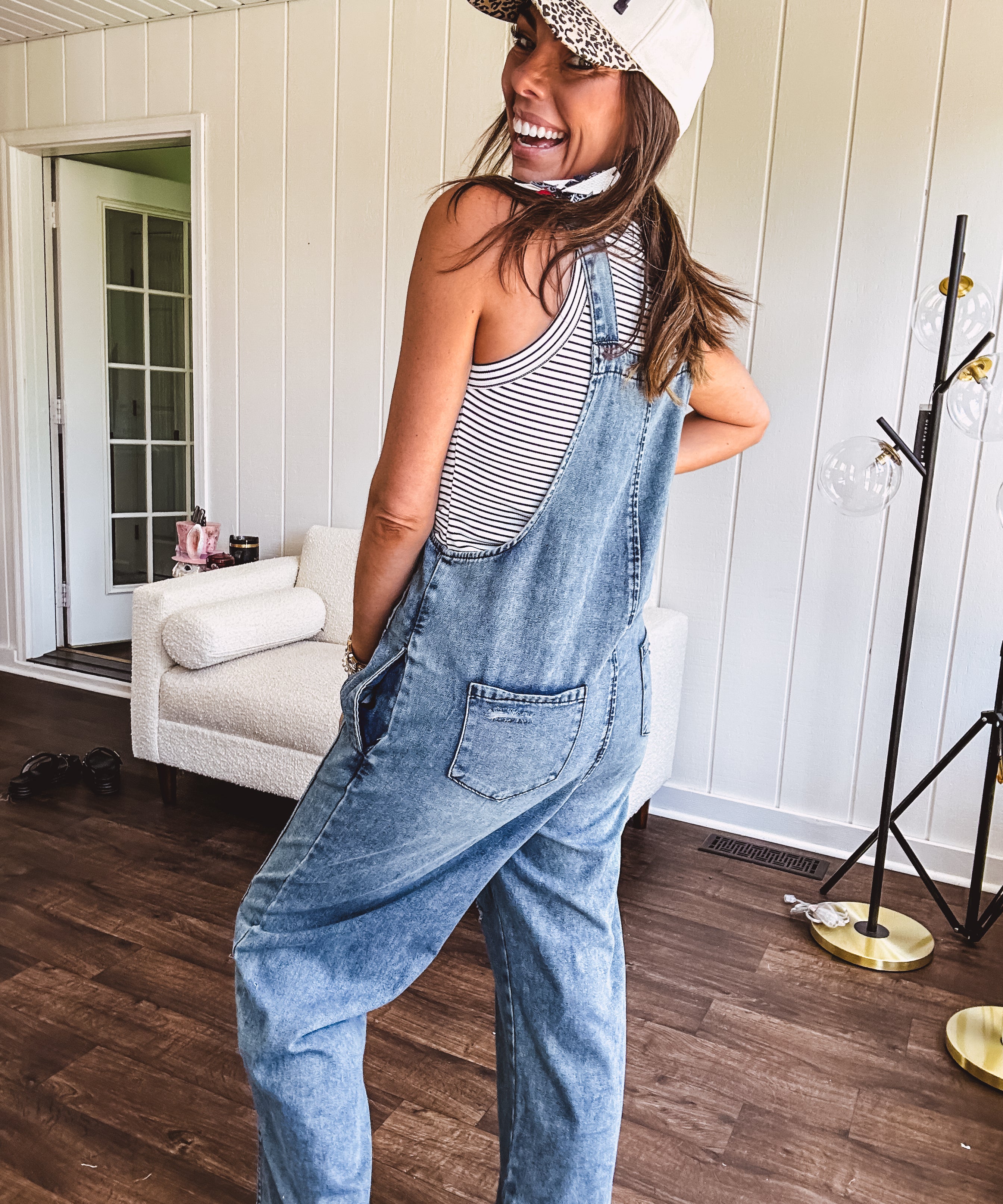 Loose fit medium wash denim overalls with adjustable button straps and sides and distressing throughout.
