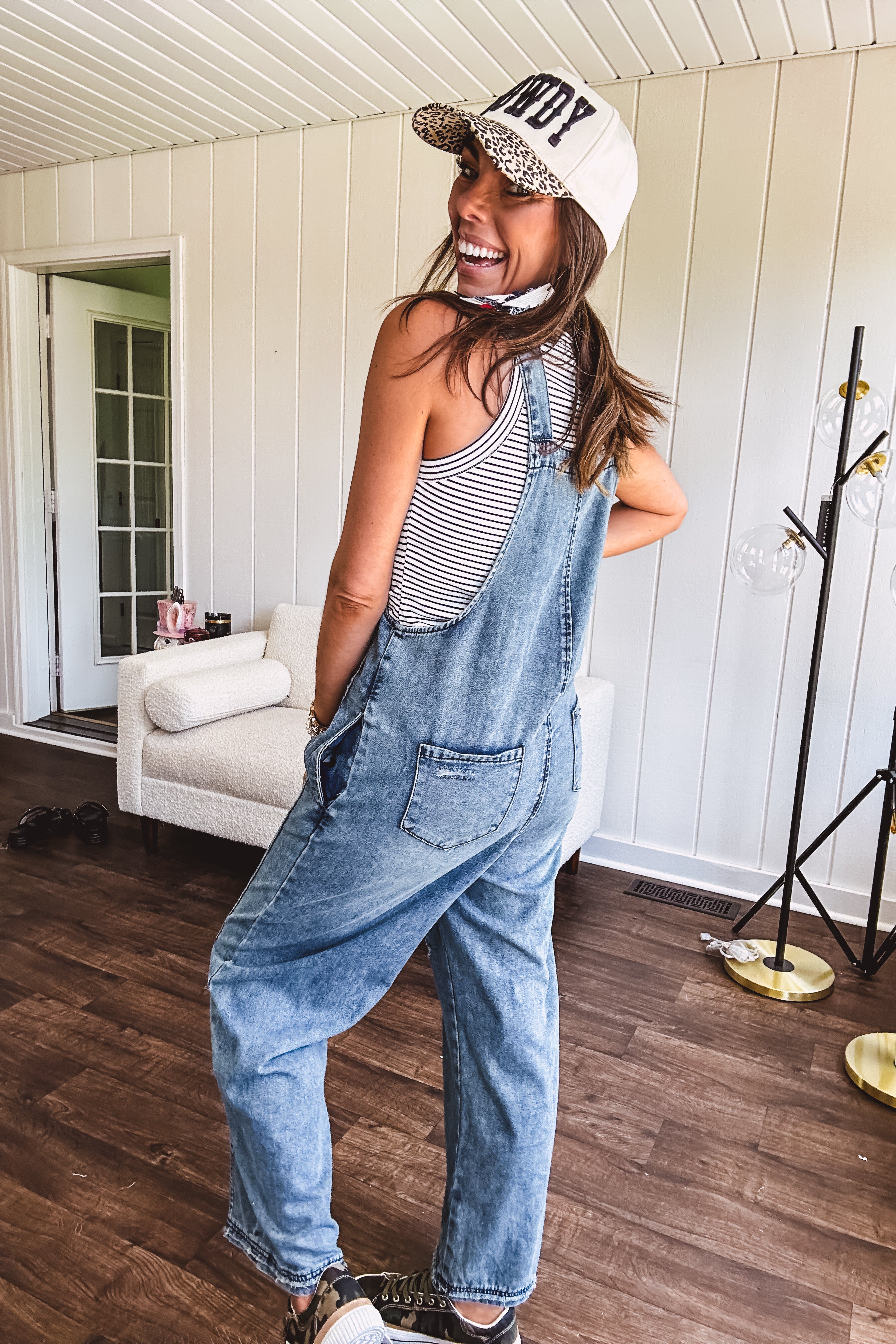 Loose fit medium wash denim overalls with adjustable button straps and sides and distressing throughout.