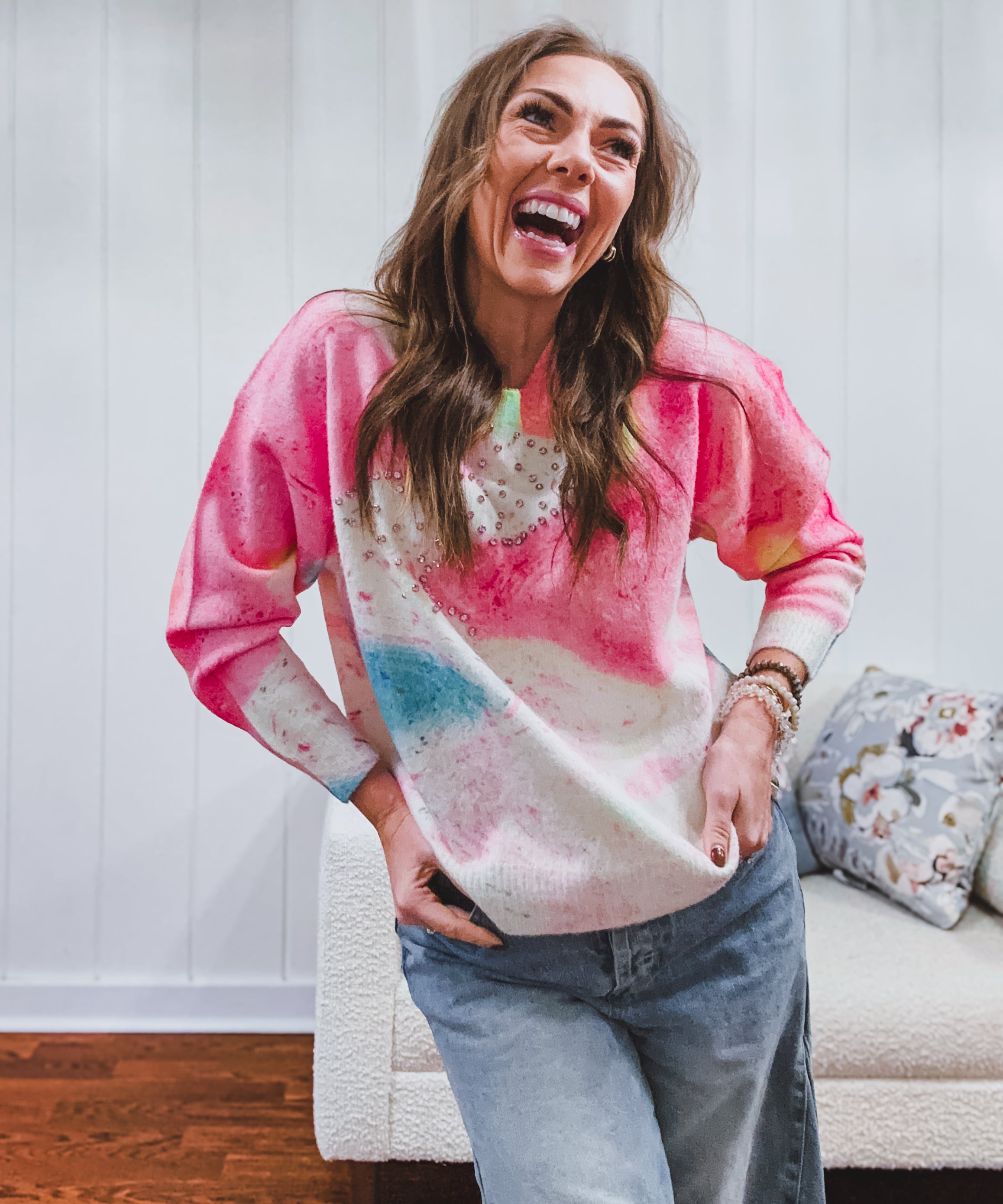 Crew style sweater featuring pastel swirl patterns in pink, blue and yellow accentuated by rhinestones.