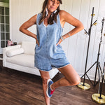 Medium mineral wash denim jumper with V neck, zipper back and white trim throughout. Has pockets.