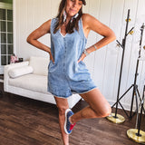 Medium mineral wash denim jumper with V neck, zipper back and white trim throughout. Has pockets.