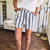Cotton blend cream and navy striped shorts with full lining, hook and zipper closure, elastic back at the waist and side pockets with faux back pockets.
