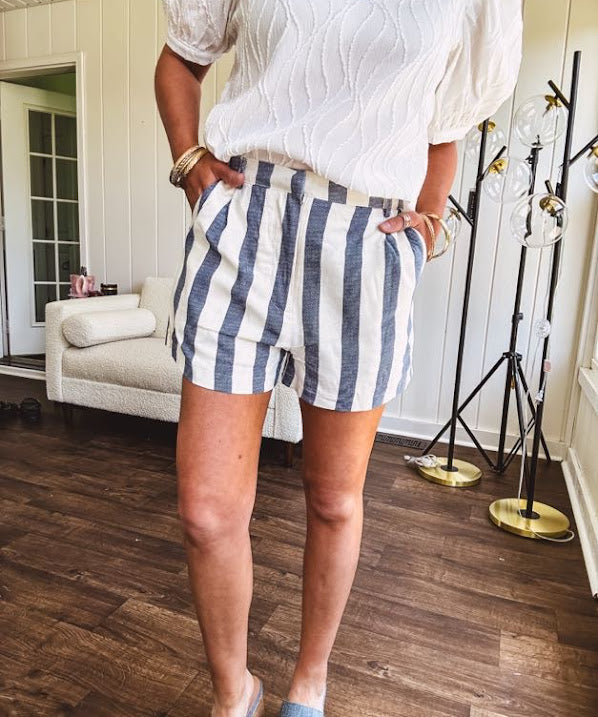 Cotton blend cream and navy striped shorts with full lining, hook and zipper closure, elastic back at the waist and side pockets with faux back pockets.