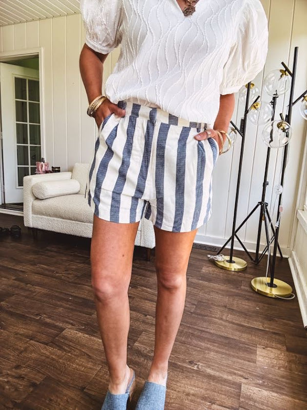 Cotton blend cream and navy striped shorts with full lining, hook and zipper closure, elastic back at the waist and side pockets with faux back pockets.