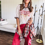 Floral lace sheer tee with brown trim throughout and red "FREEBIRD" and cream eagle graphic.