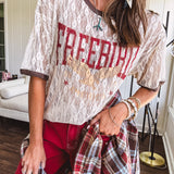 Floral lace sheer tee with brown trim throughout and red "FREEBIRD" and cream eagle graphic.