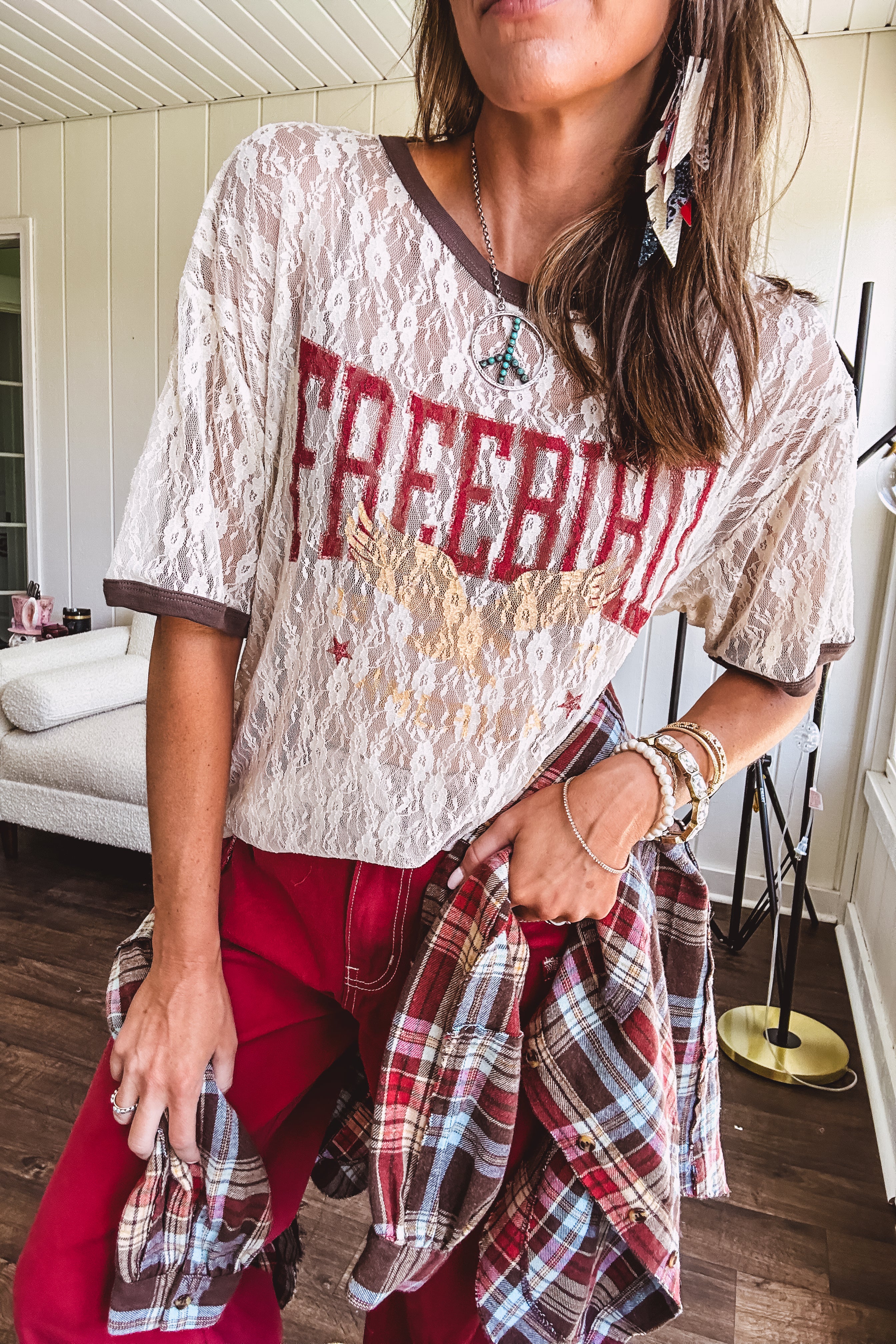 Floral lace sheer tee with brown trim throughout and red "FREEBIRD" and cream eagle graphic.