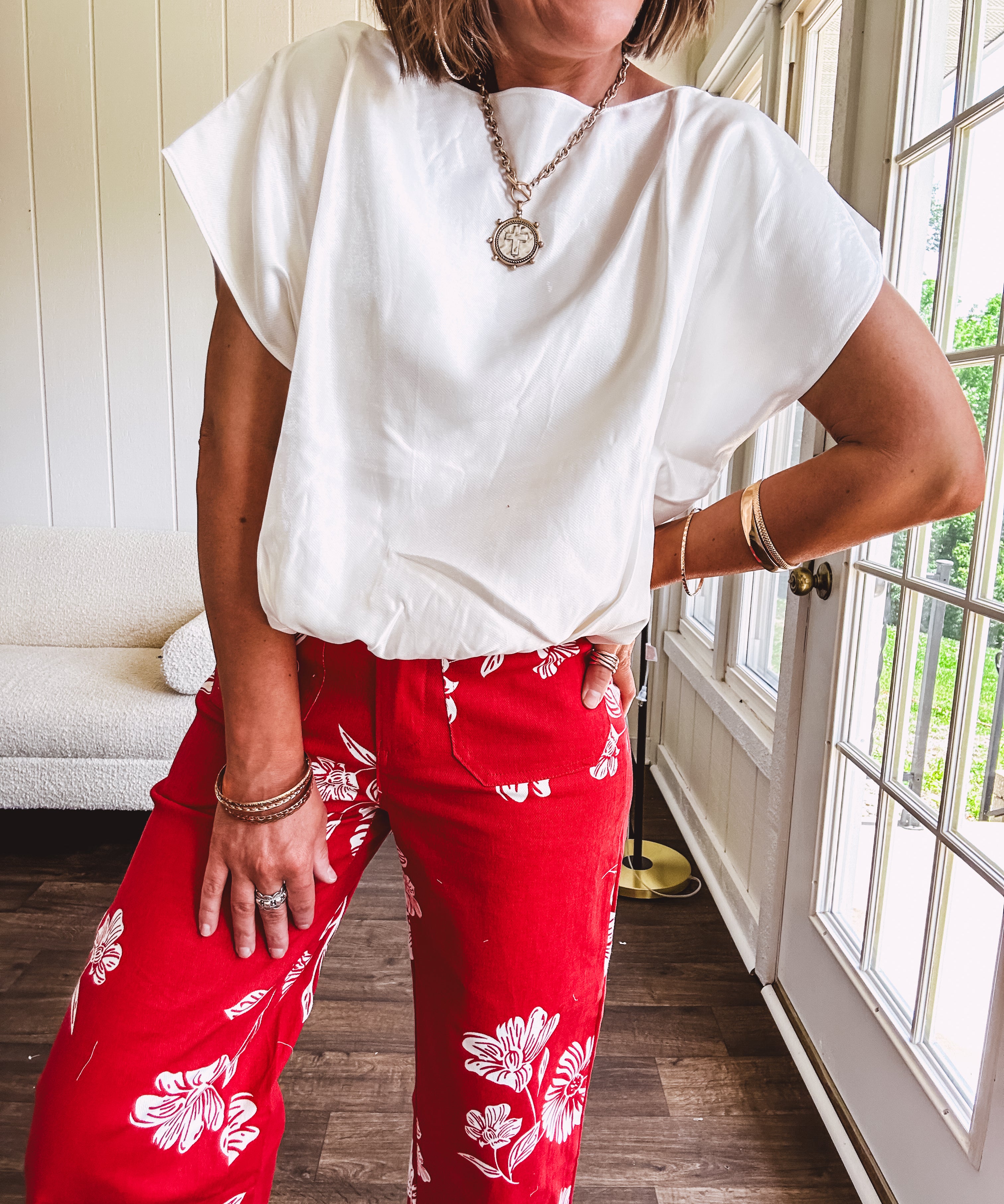 Shimmery white short sleeved top with elastic bubble hem and boat neck design.