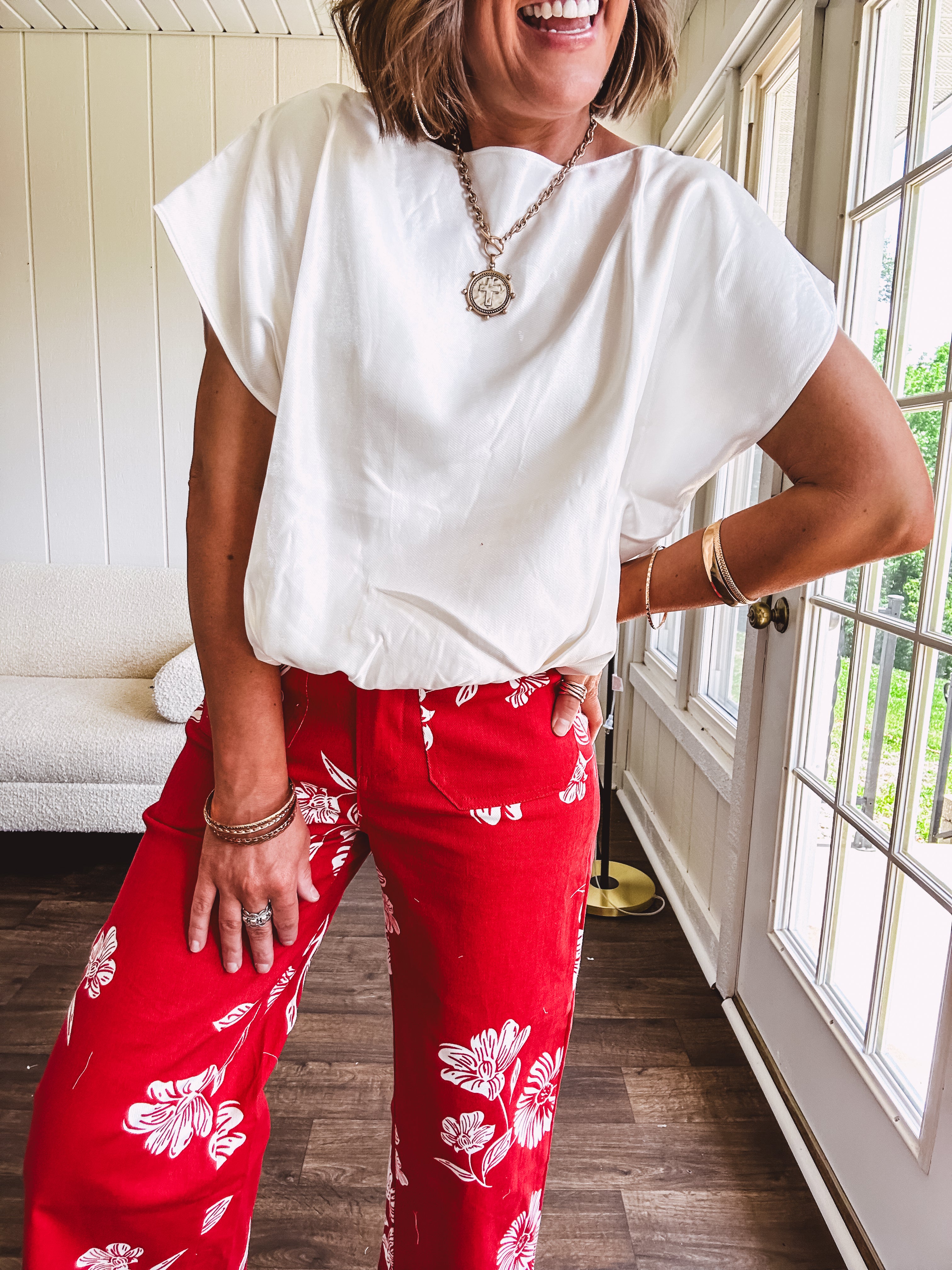 Shimmery white short sleeved top with elastic bubble hem and boat neck design.