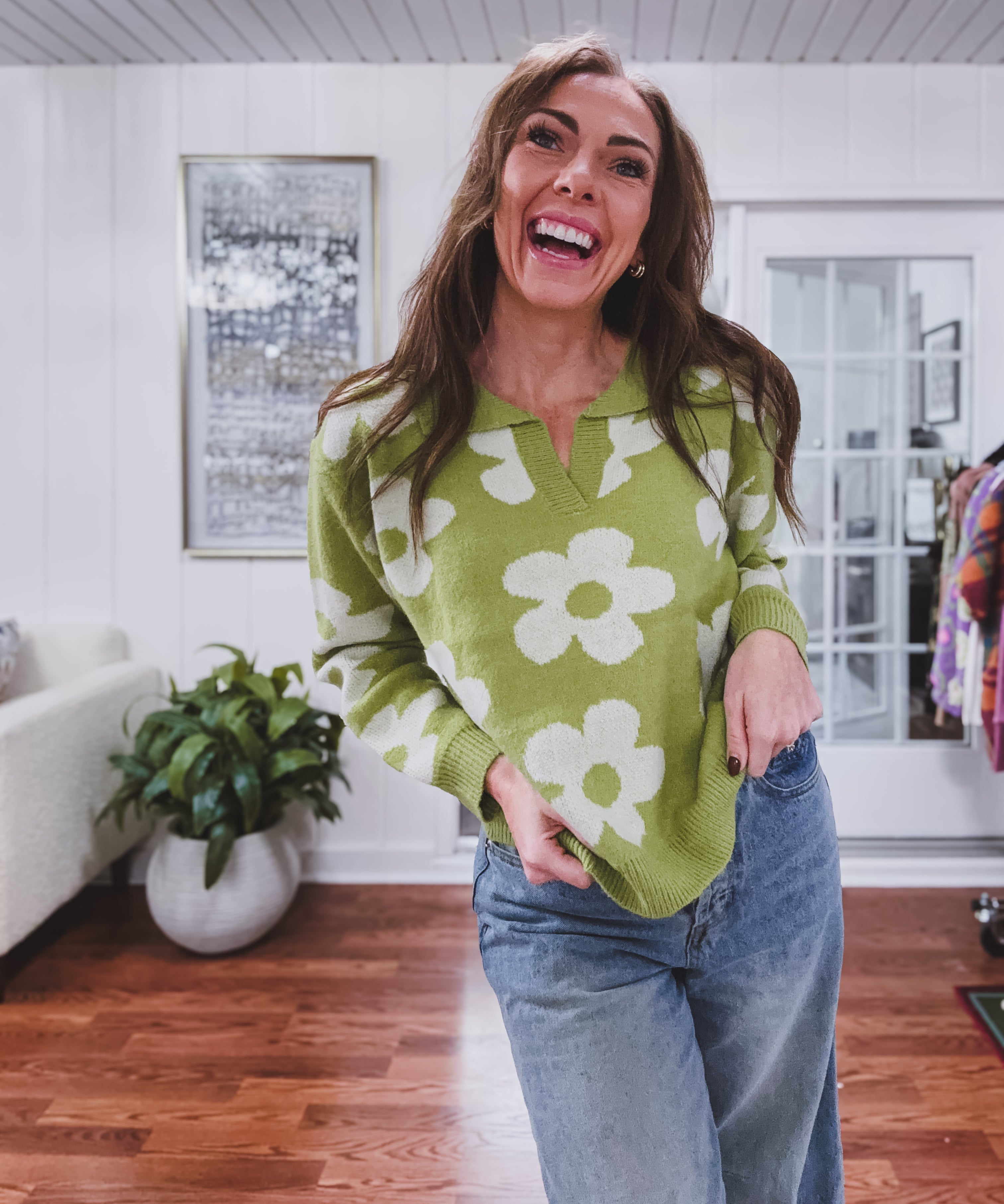 Bright green sweater with large ivory daisy design, classic V neck and collar.