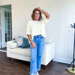 Soft, lightweight stretchy fabric in stripes including black and white, cream and white with contrasting trim at the round neck, hemline and sleeves. short sleeved and boxy cut.