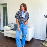 Light wash high rise denim with stretch, zipper button closure, minimal distressing and raw cutout at the hem with a straight leg design that is slim through the thighs.