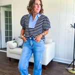 Navy and cream striped soft, stretchy top with light blue cotton collar and V neck with cuffed puff sleeves.