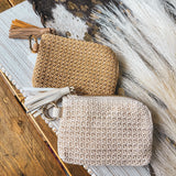 Small raffia card in or change holder in cream or tan with gold zipper, matching tassel and D ring for easy clipping to purse.