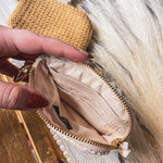 Small raffia card or change holder in cream or tan with gold zipper, matching tassel and D ring for easy clipping to purse.