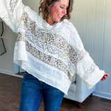Soft, feminine and fun, this cream mixed textured pullover is your new go-to for effortless boho vibes. Lace details play beautifully with muted yellow and purple floral inserts, while 3/4 wide sleeves and matching rope drawstrings add that perfect playful touch. The relaxed, oversized fit? Perfect.