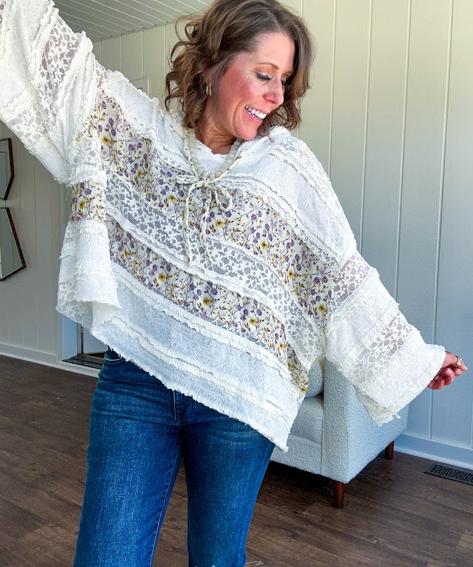 Soft, feminine and fun, this cream mixed textured pullover is your new go-to for effortless boho vibes. Lace details play beautifully with muted yellow and purple floral inserts, while 3/4 wide sleeves and matching rope drawstrings add that perfect playful touch. The relaxed, oversized fit? Perfect.