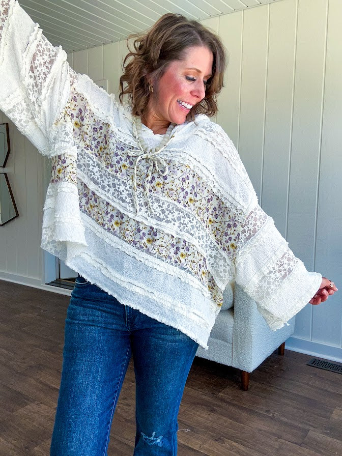 Soft, feminine and fun, this cream mixed textured pullover is your new go-to for effortless boho vibes. Lace details play beautifully with muted yellow and purple floral inserts, while 3/4 wide sleeves and matching rope drawstrings add that perfect playful touch. The relaxed, oversized fit? Perfect.