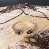 Authentic sterling silver balls surround a genuine Tiger's Eye oval on each end of this adjustable cuff with a sterling silver band.