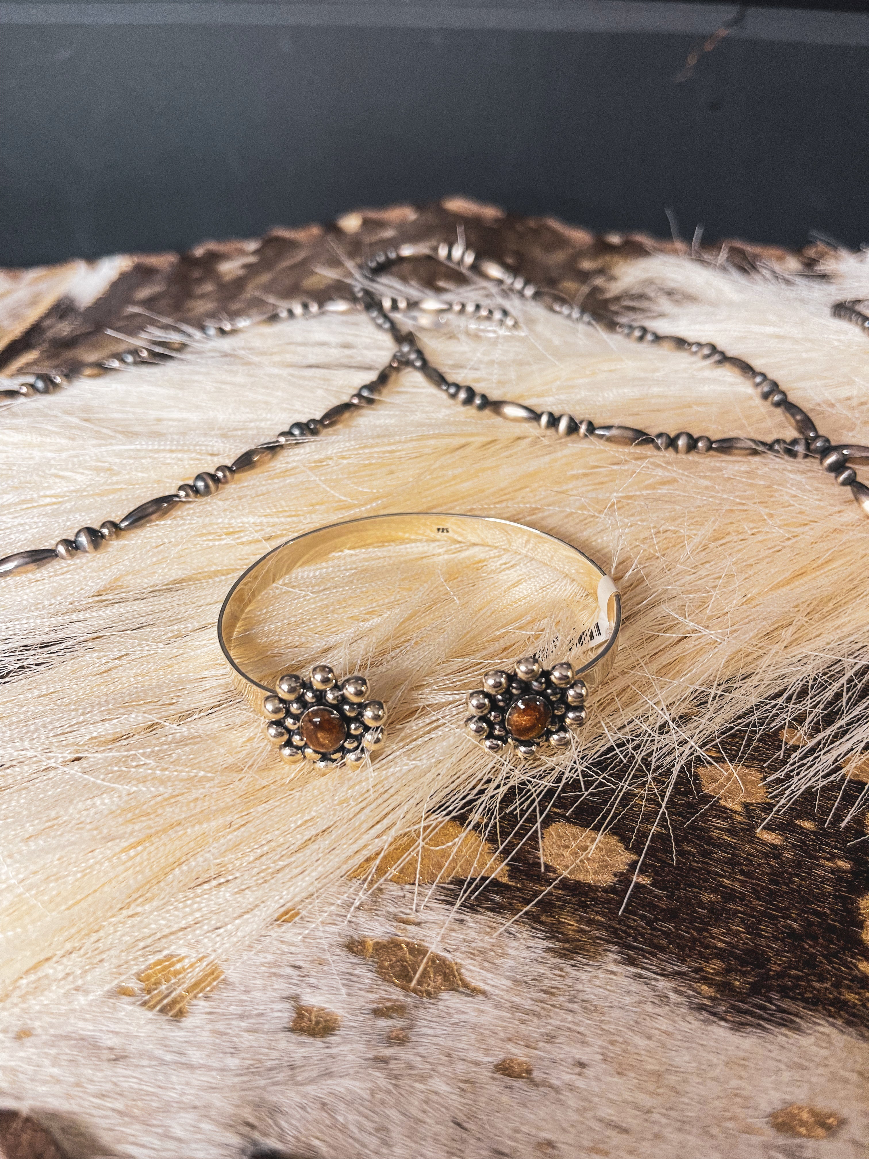 Authentic sterling silver balls surround a genuine Tiger's Eye oval on each end of this adjustable cuff with a sterling silver band.