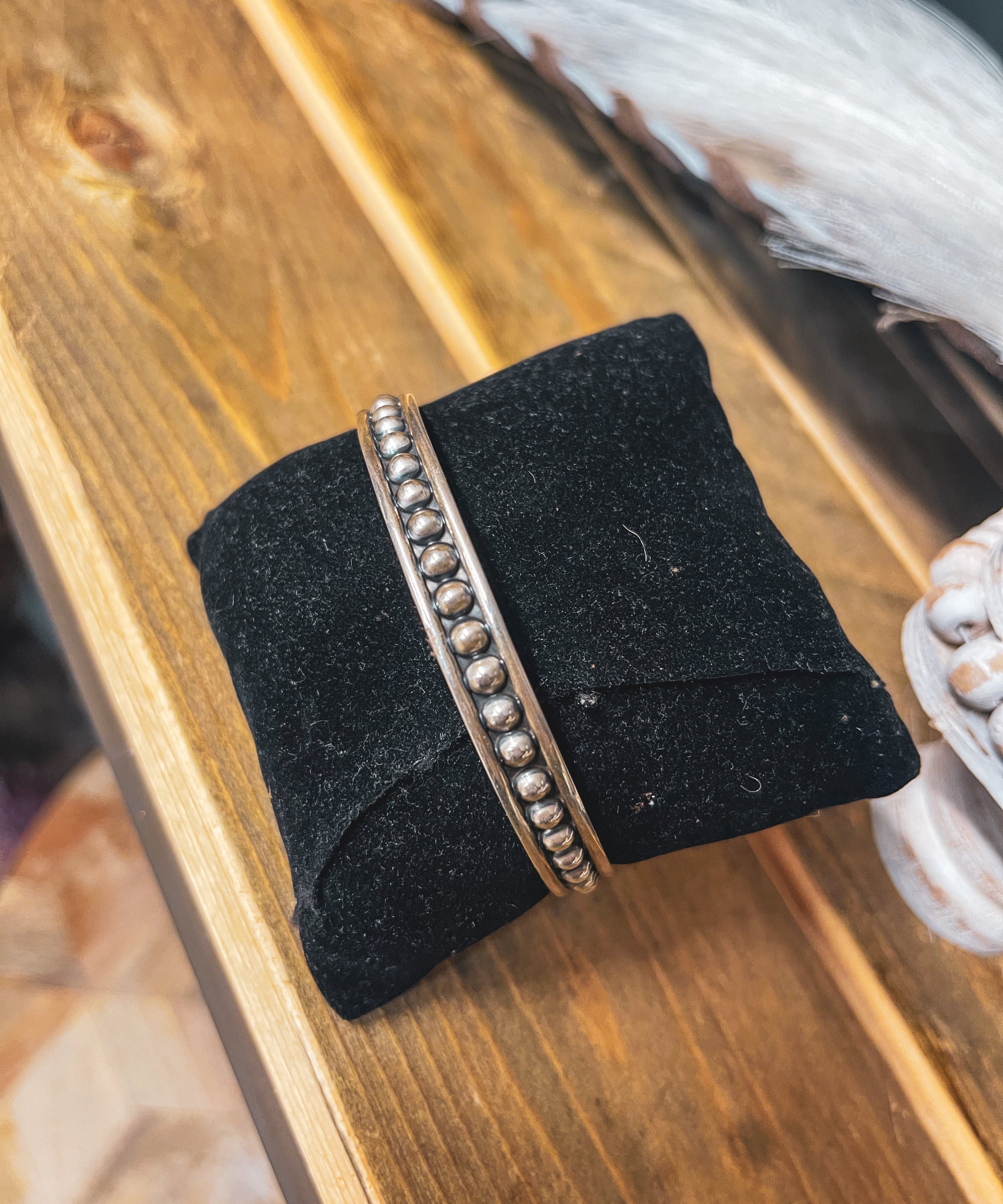 Authentic Sterling Silver bangle featuring silver balls on an oxidized background.