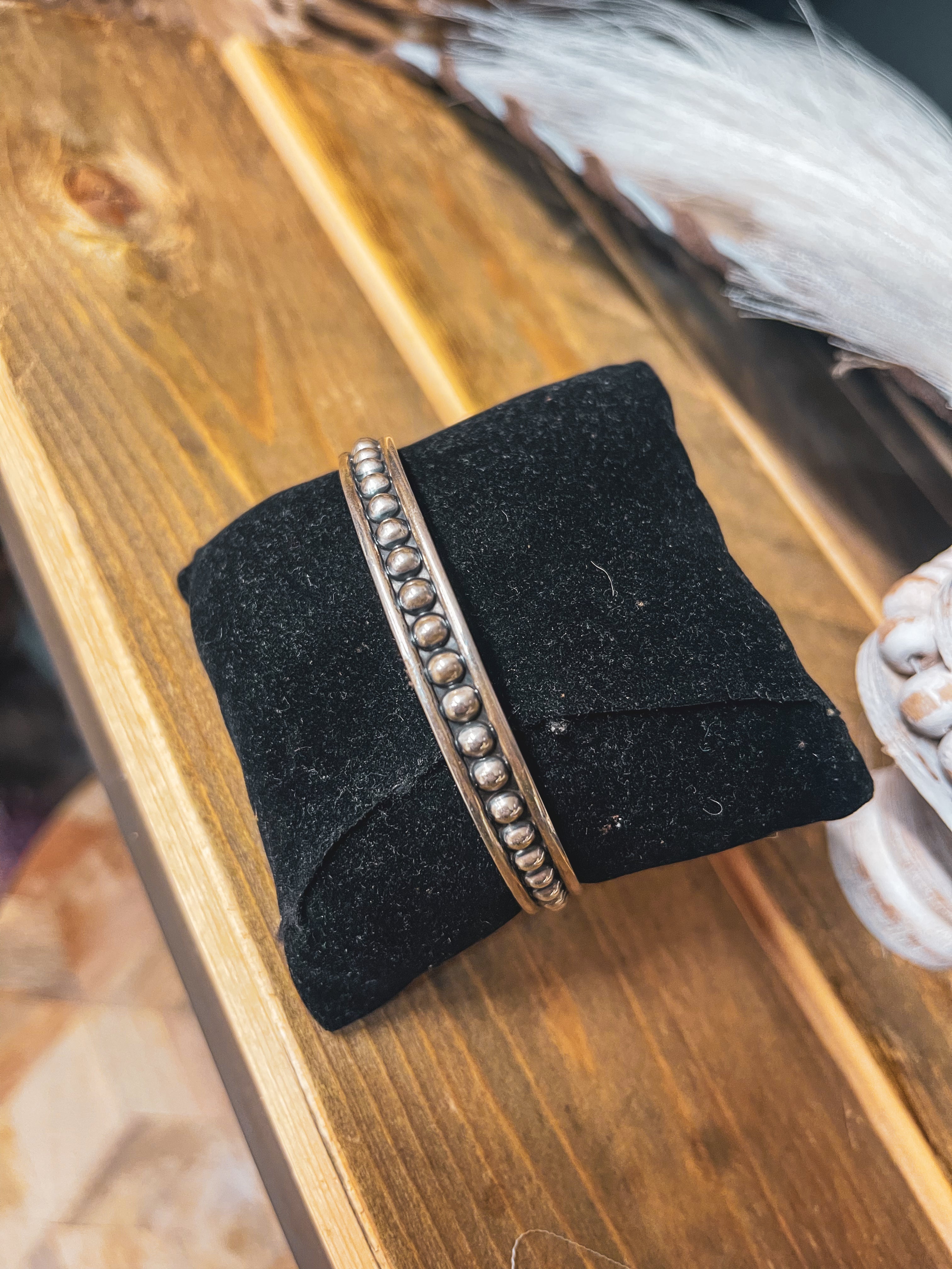 Authentic Sterling Silver bangle featuring silver balls on an oxidized background.