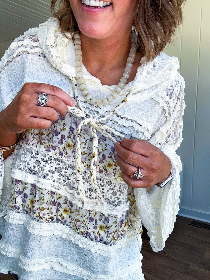Soft, feminine and fun, this cream mixed textured pullover is your new go-to for effortless boho vibes. Lace details play beautifully with muted yellow and purple floral inserts, while 3/4 wide sleeves and matching rope drawstrings add that perfect playful touch. The relaxed, oversized fit? Perfect.