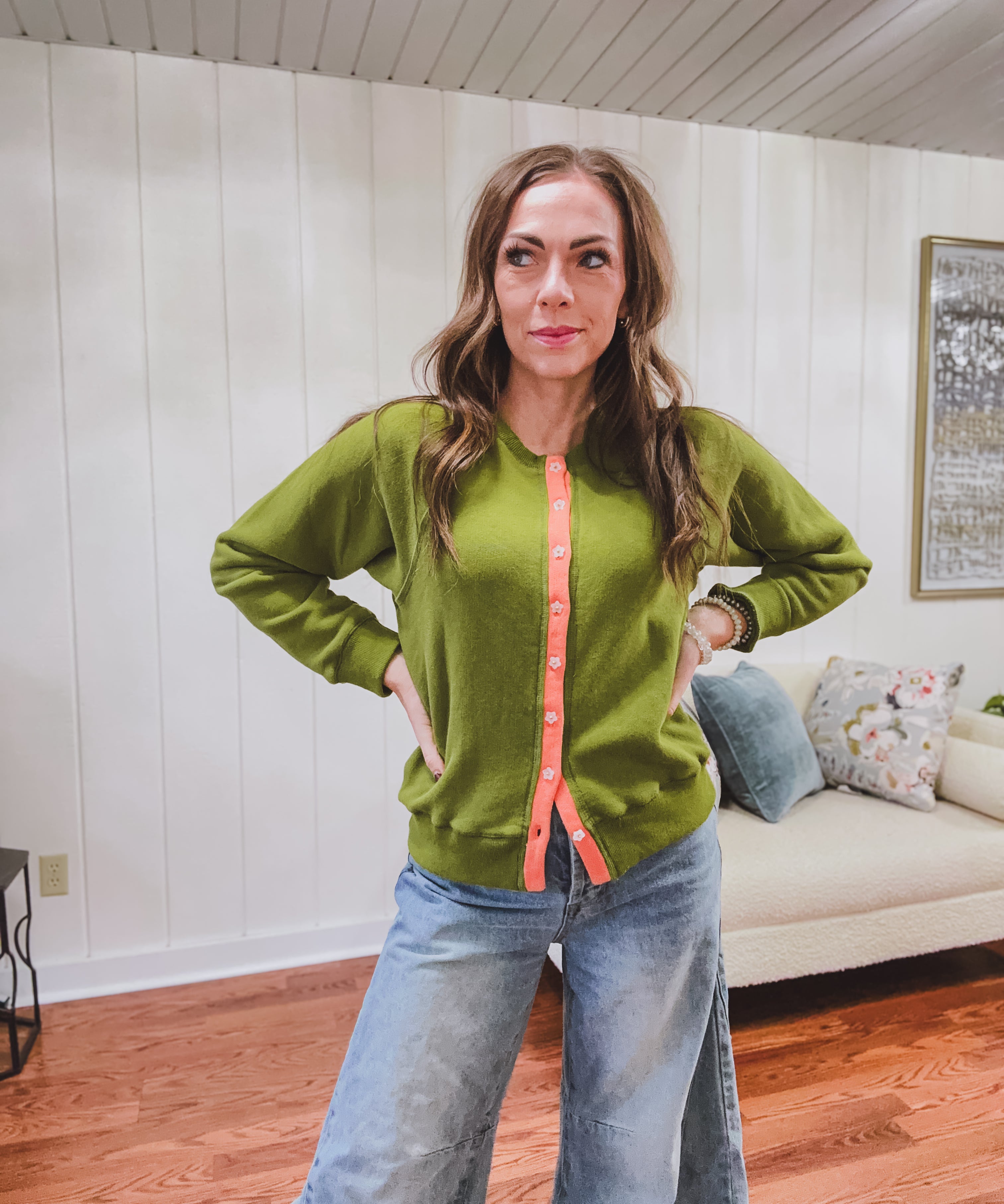 Button front cardigan sweater in a bold green with contrasting coral along the buttons with gold floral buttons.