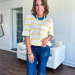 A boxy cream open weave knit that's equal parts playful and put-together. Sunshine-yellow stripes dance across the fabric while a bold teal collar and scalloped sleeve trim steal the show. The front pocket? Pure casual genius.