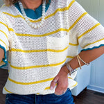 A boxy open weave cream knit that's equal parts playful and put-together. Sunshine-yellow stripes dance across the fabric while a bold teal collar and scalloped sleeve trim steal the show. The front pocket? Pure casual genius.