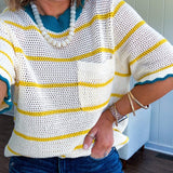 A boxy open weave cream knit that's equal parts playful and put-together. Sunshine-yellow stripes dance across the fabric while a bold teal collar and scalloped sleeve trim steal the show. The front pocket? Pure casual genius.