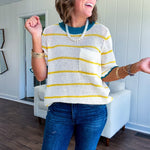 A boxy cream open weave knit that's equal parts playful and put-together. Sunshine-yellow stripes dance across the fabric while a bold teal collar and scalloped sleeve trim steal the show. The front pocket? Pure casual genius.