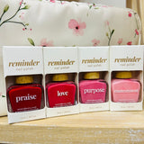 Nail polish in shades of red and pink with a QR code for worship verses.