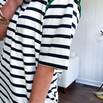 Black and cream striped short sleeved mini dress with green crochet trim at the shoulders. Has pockets.